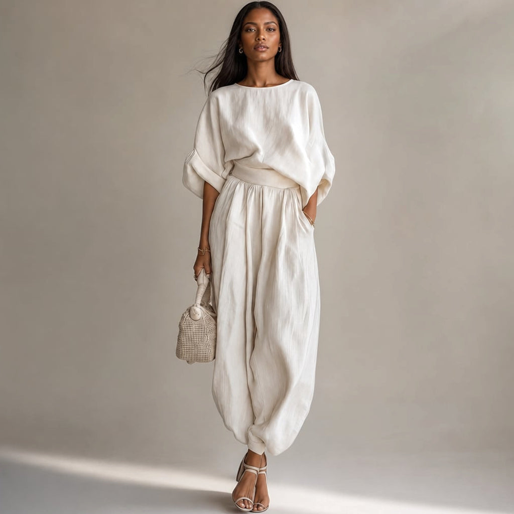 Modelo con conjunto de lino blanco blusa drapeada y pantalón pierna ancha tiro alto