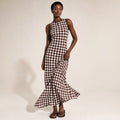 Modelo de frente con vestido maxi chocolate spot de cuello redondo y hombros libres, largo hasta el suelo