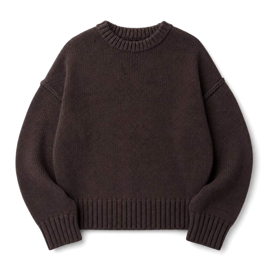 Modelo con jumper de punto chocolate, tejido cepillado y silueta relajada, combinado con pantalón de pinzas